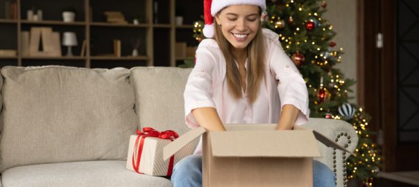 Happy,Cheerful,Girl,In,Christmas,Santa,Hat,Receiving,Delivery,Box