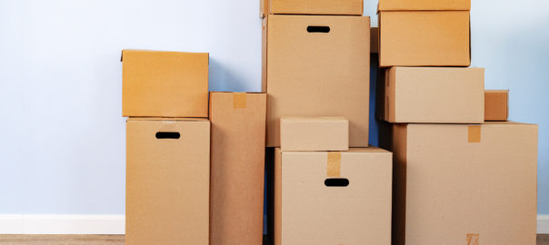 House,Moving,Concept,With,Stacked,Cardboard,Boxes,In,A,Room