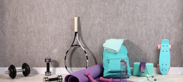 Many,Different,Sports,Equipment,Near,Grey,Wall,Indoors